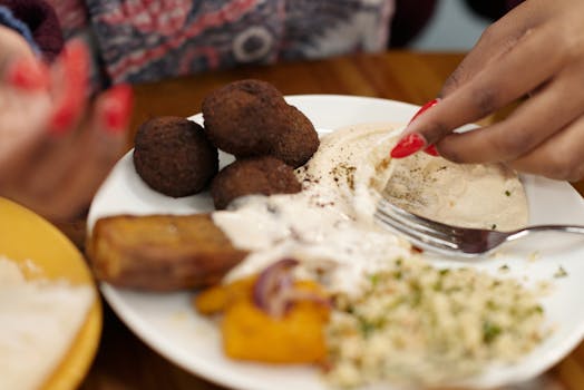 Learn to prepare homemade falafel and serve it in pitas with salad and yogurt sauce, enjoying a delicious and filling dish